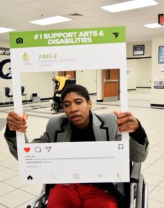 Young lady Sierra Stanley, poses with selfie image picture frame for at the Disability Awareness Career Day.