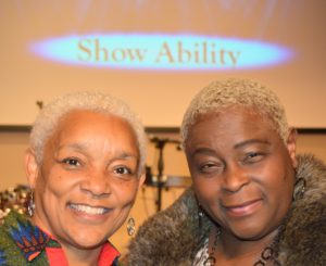 SHOWAbility Executive Director Myrna Clayton and Board CHair Twanda Black smile in photo together.