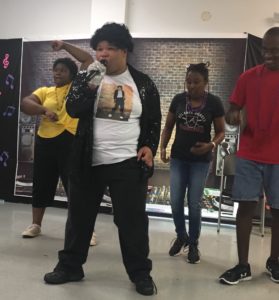 Young adult male with a developmental disability impersonates Michael Jackson for his talent. He has female dancers and one male dancer as part of his act.